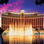 a large building with a fountain in front of it with Bellagio in the background