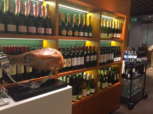 a shelf with wine bottles and a piece of meat