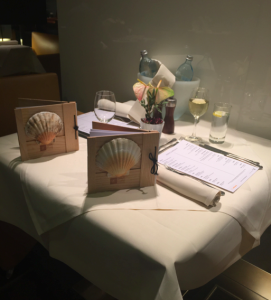 a table with a menu and glasses on it