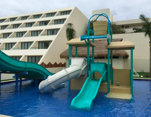 a water park with a slide and a building
