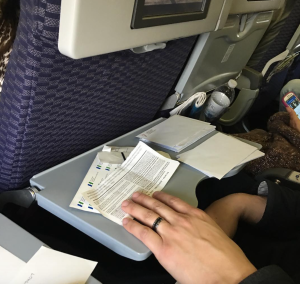 a person holding a paper on a tray