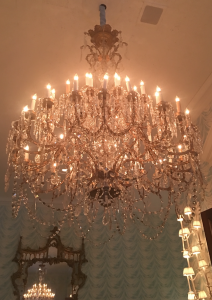 a chandelier with candles on the ceiling