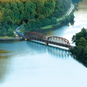 a train going over a bridge over a river