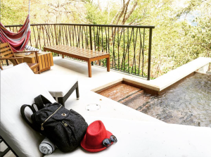 a backpack and hat on a deck