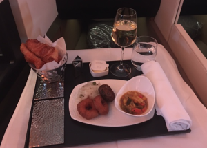 a tray with food and wine on it