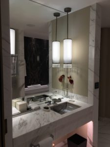 a bathroom with marble countertop and sink