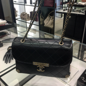 a black handbag on a glass display case