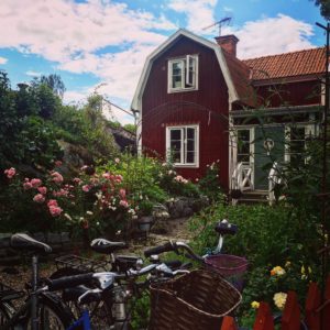 a house with a red barn and bicycles in front of it