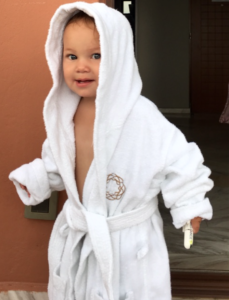 a baby wearing a white robe