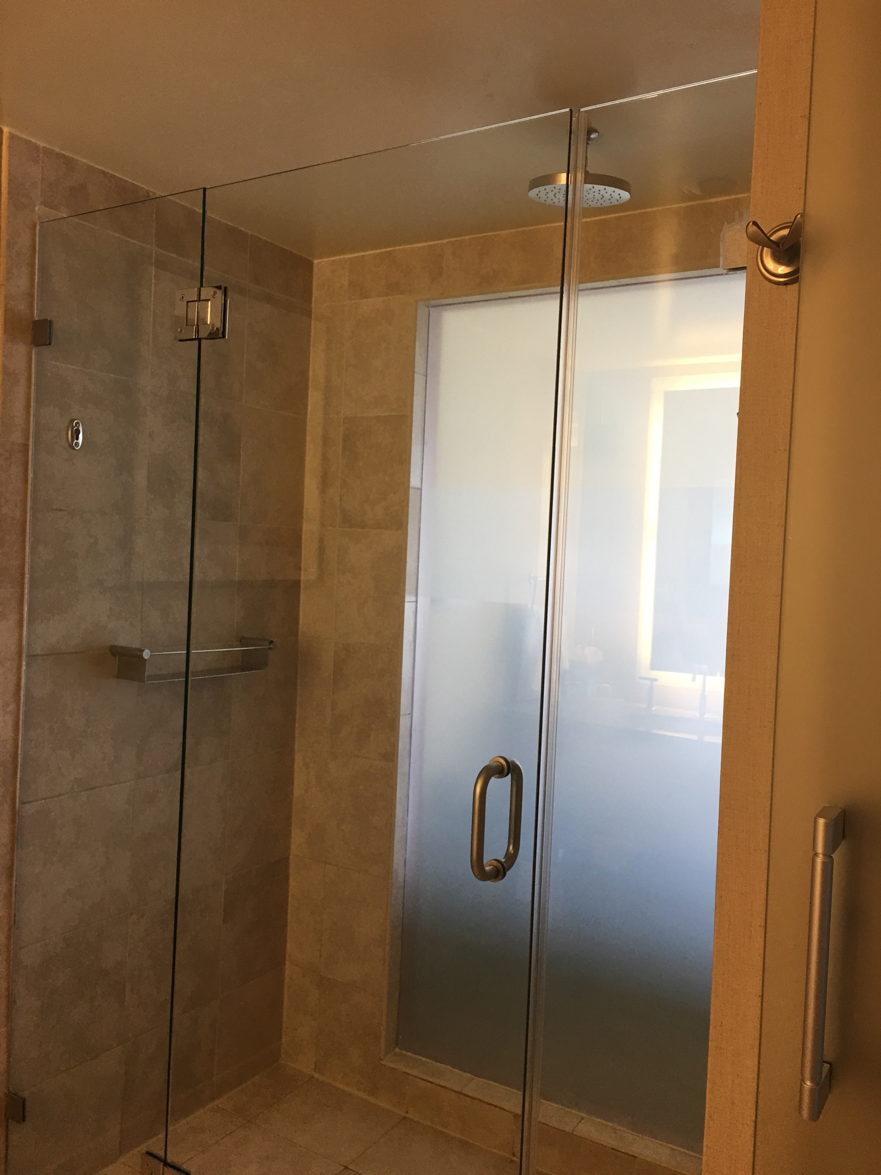 a glass shower with a shower head