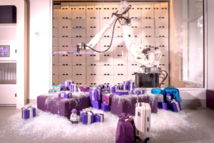 a robot arm with purple and white boxes and purple bags