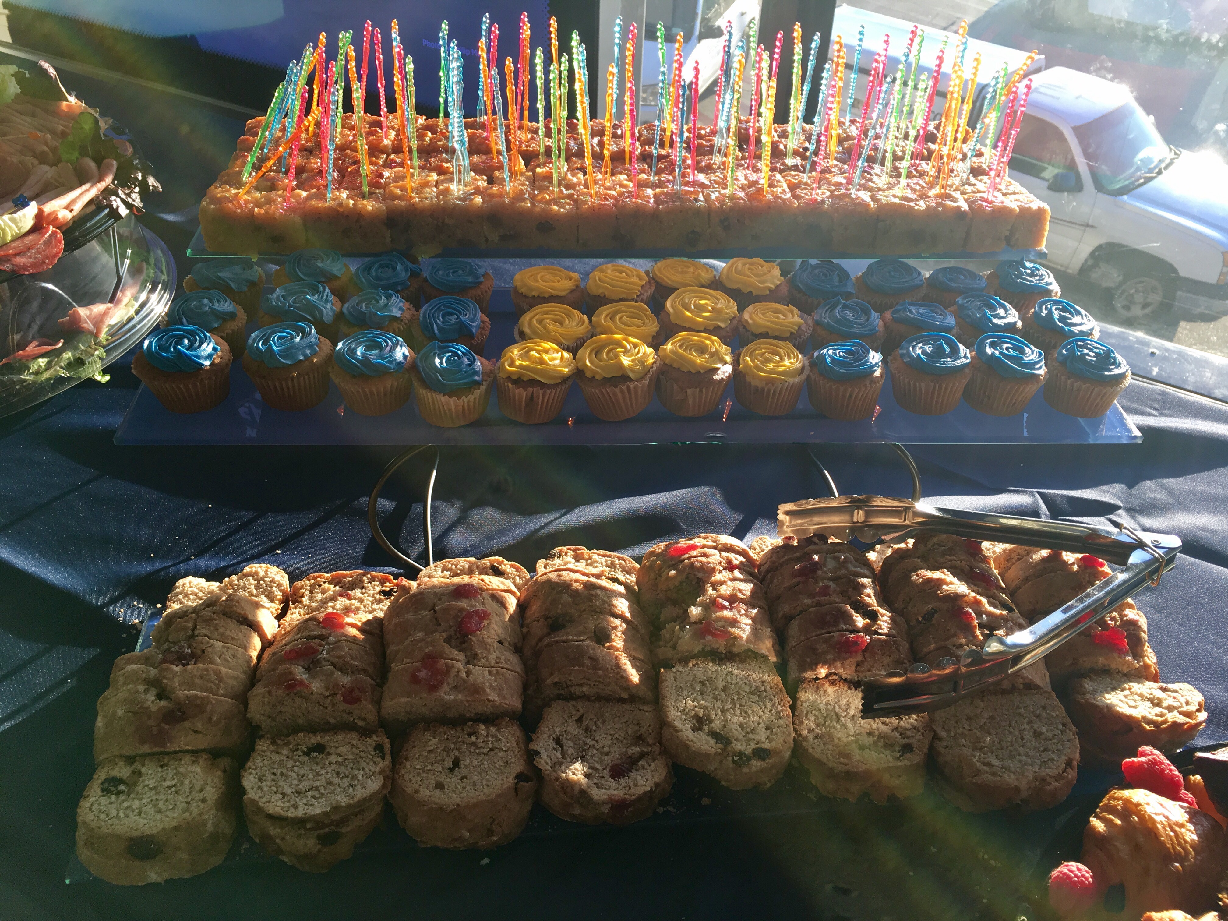 a display of cupcakes and cakes