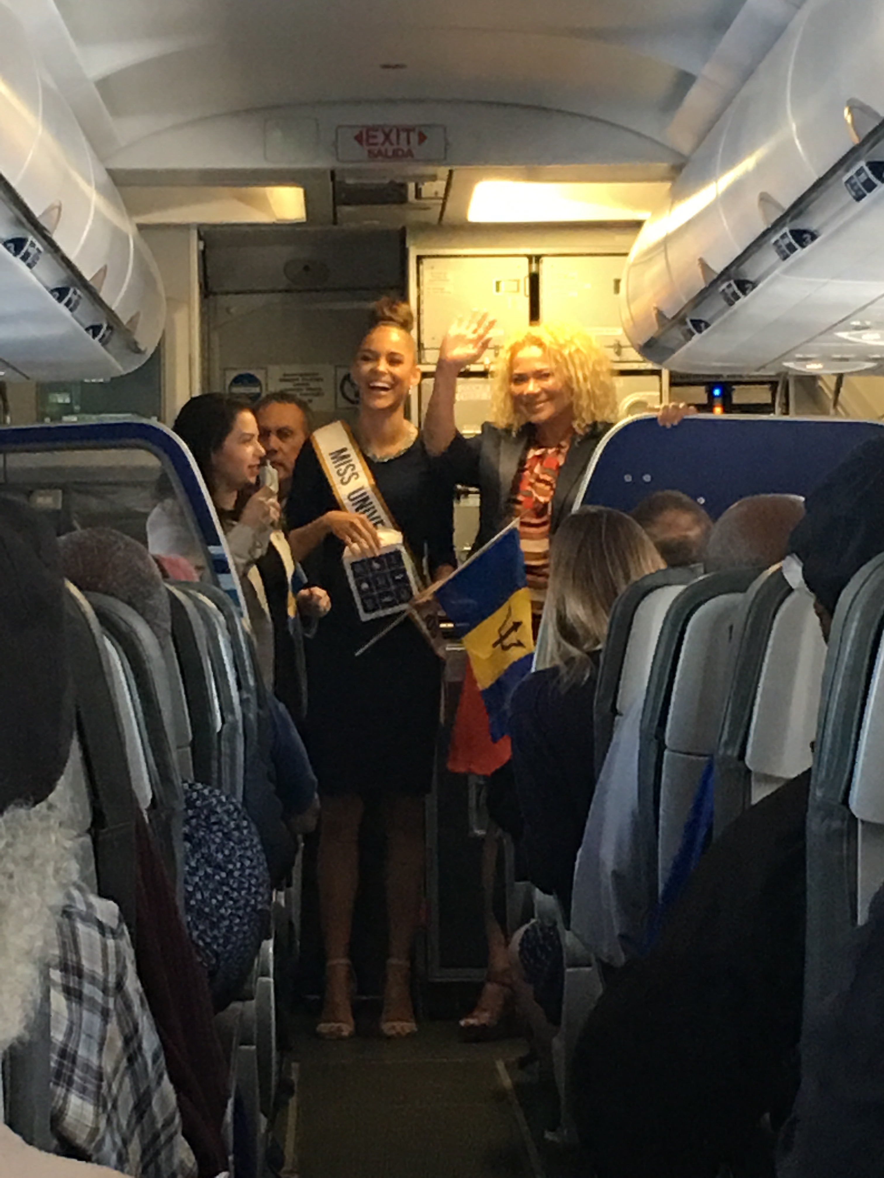 a group of women standing in an airplane
