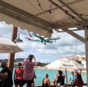 a plane flying over a beach