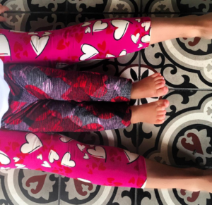 a pair of legs with hearts on the leggings