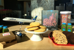 a plate of cookies and a model airplane on a table