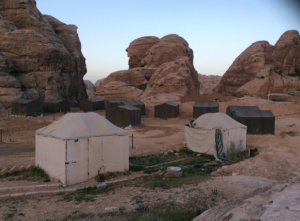 tents in a desert with large rocks