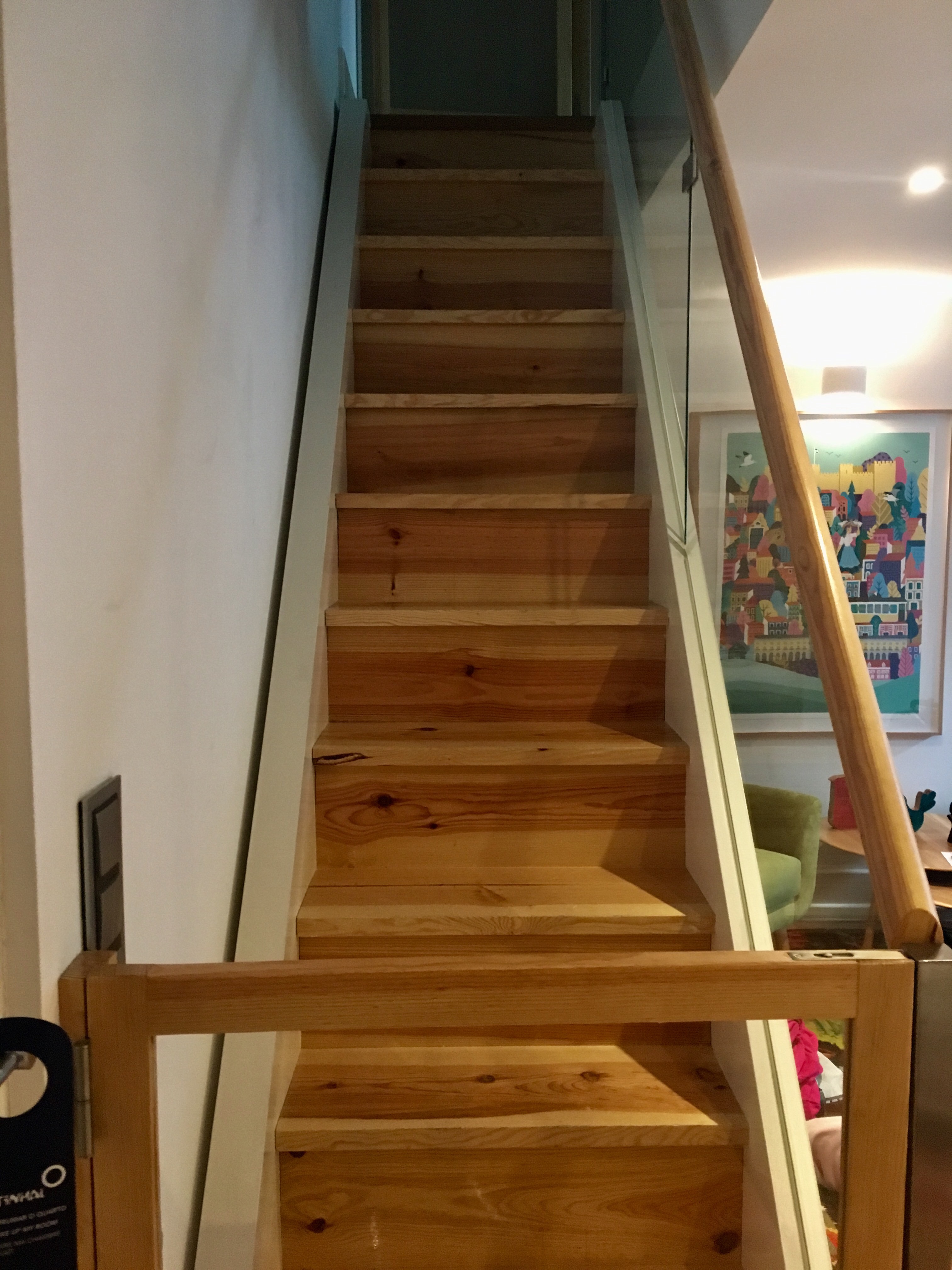 a wooden stairs with glass railing