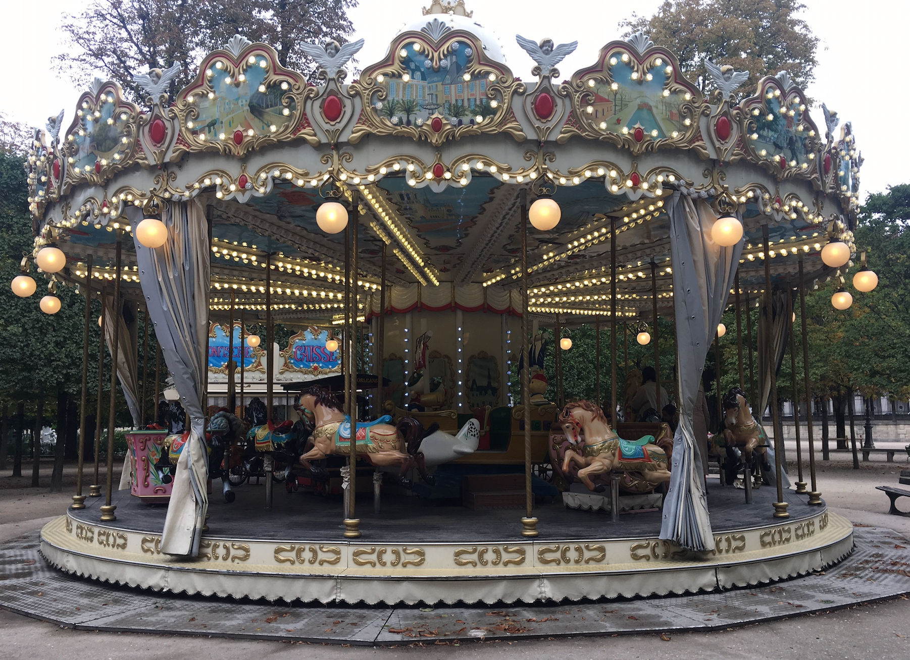 a merry go round with lights and horses