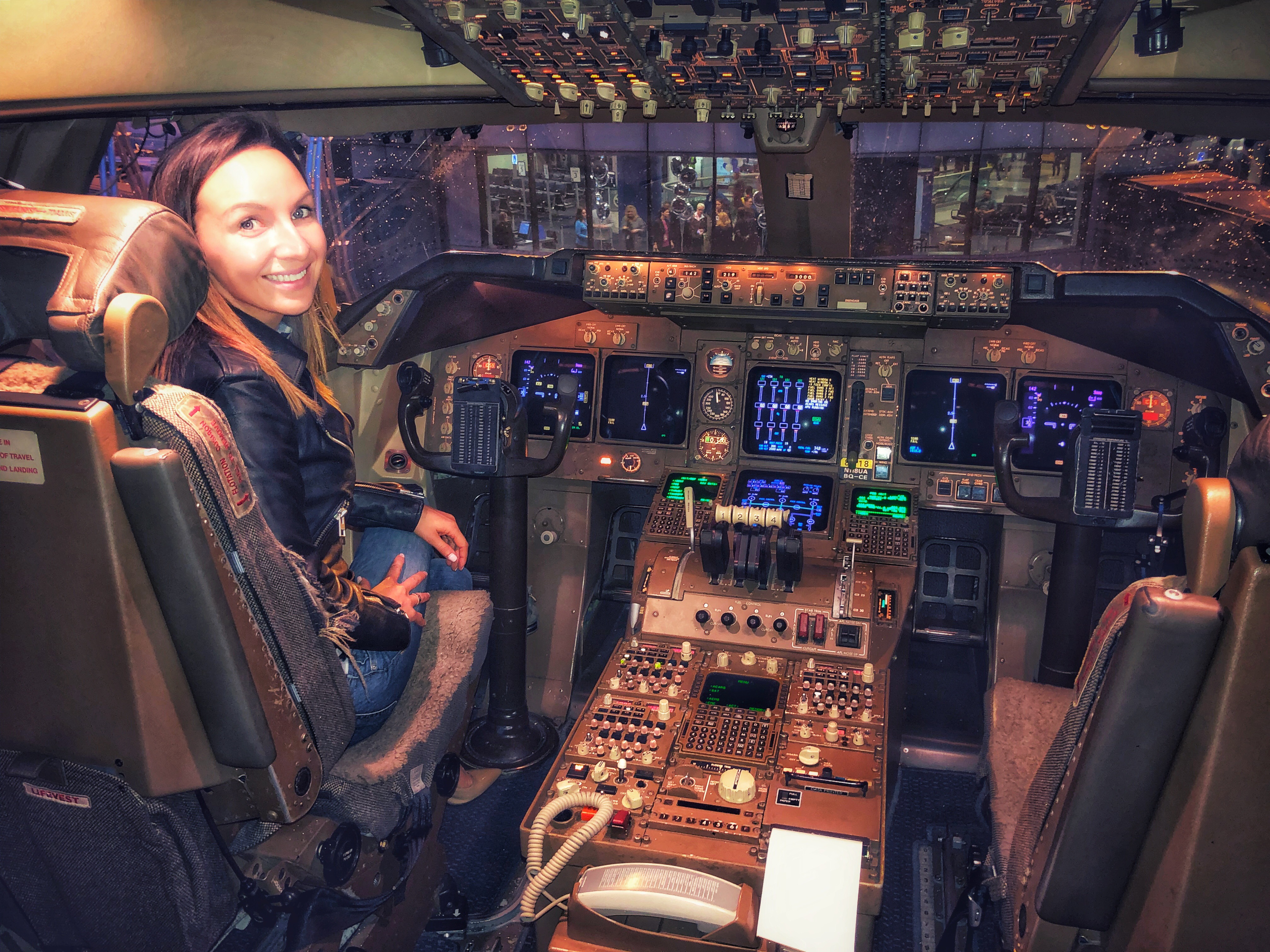 a woman sitting in a cockpit of an airplane