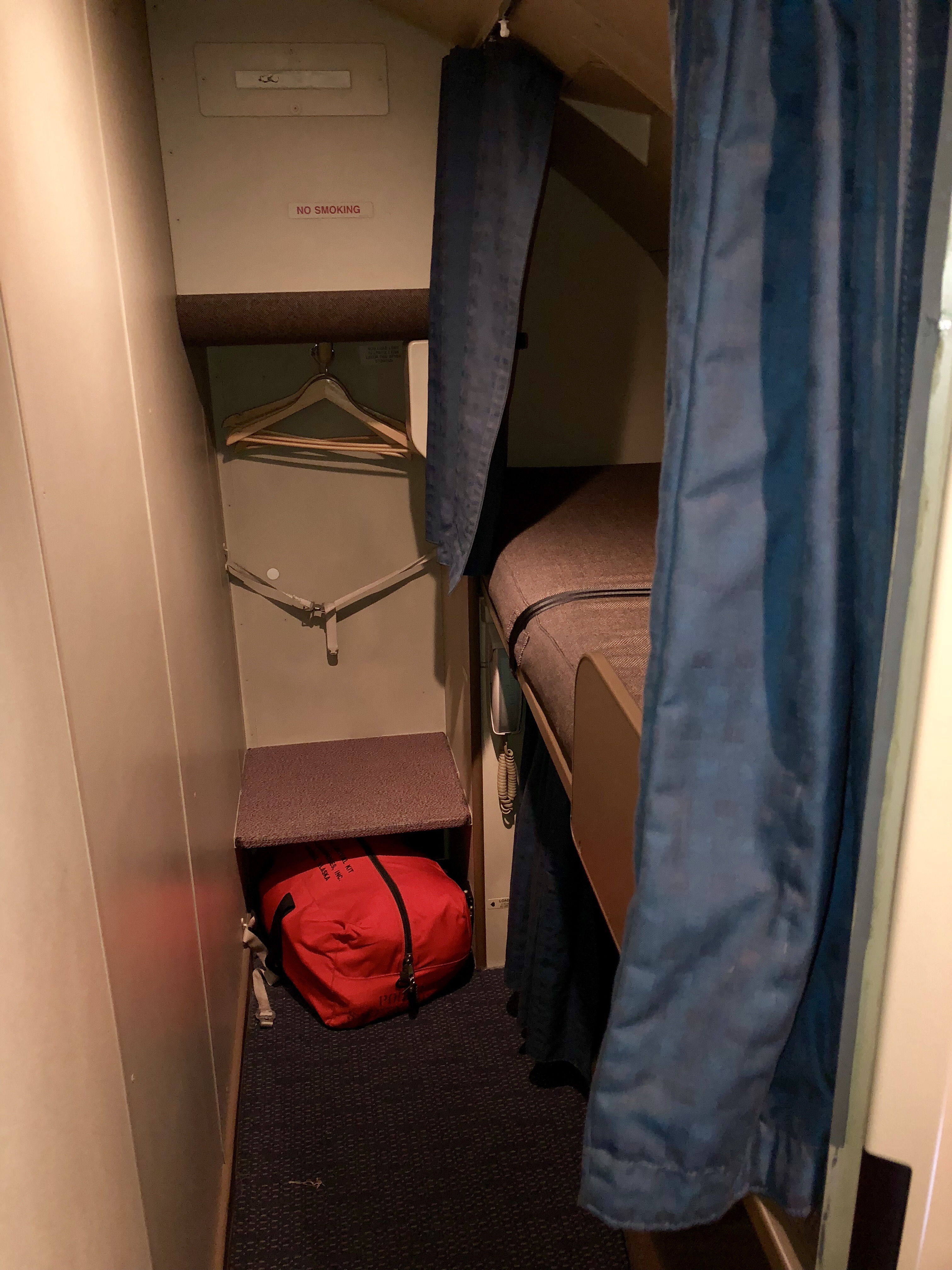 a small room with a red bag and swingers