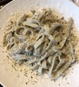 a plate of pasta with seasoning