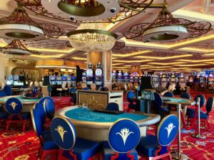 a casino with a large round table and blue chairs