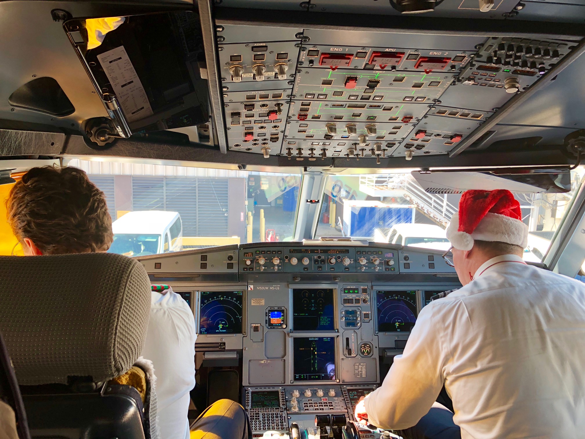 a man in a hat in a cockpit of a plane