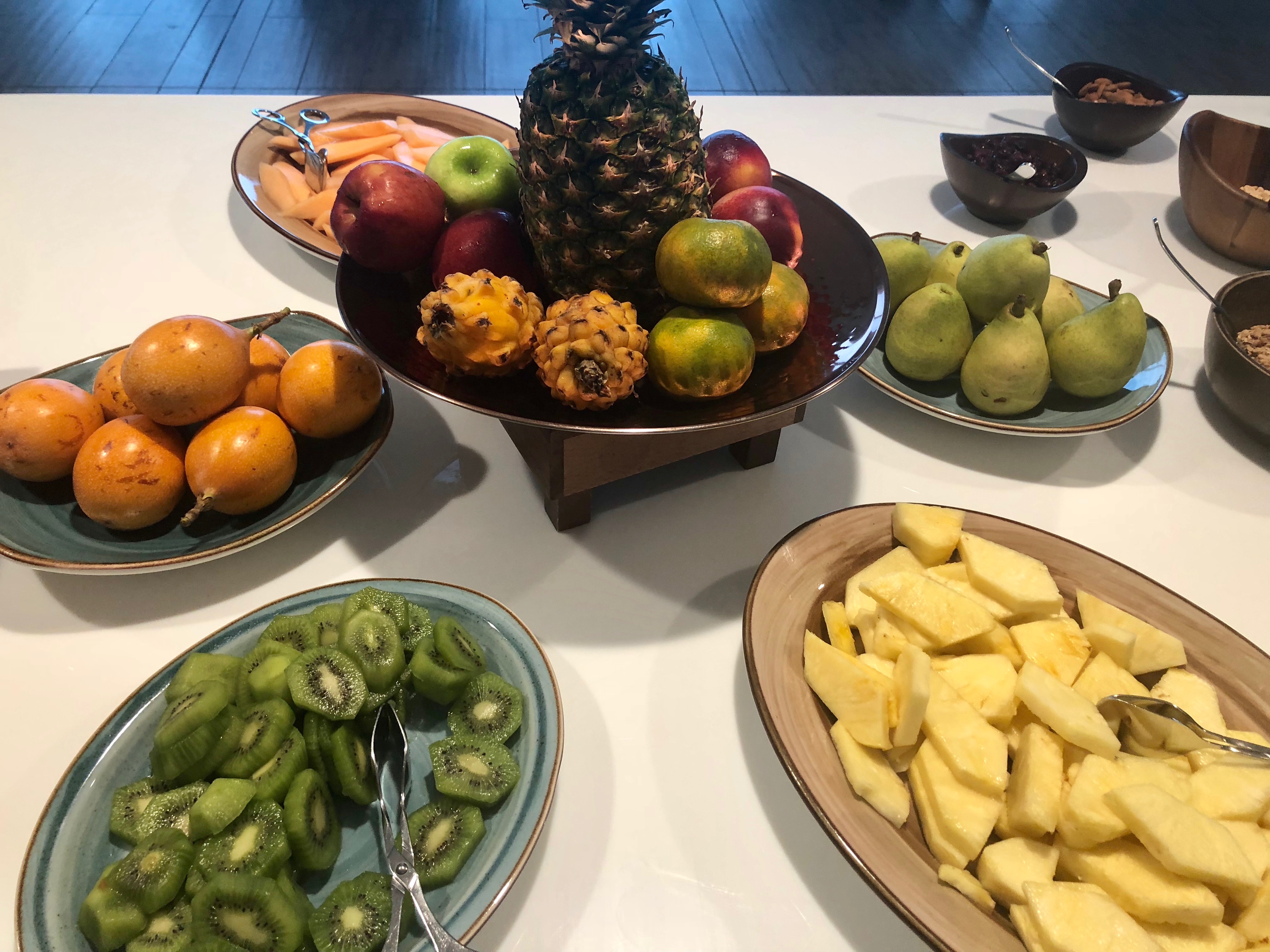 a table with plates of fruit