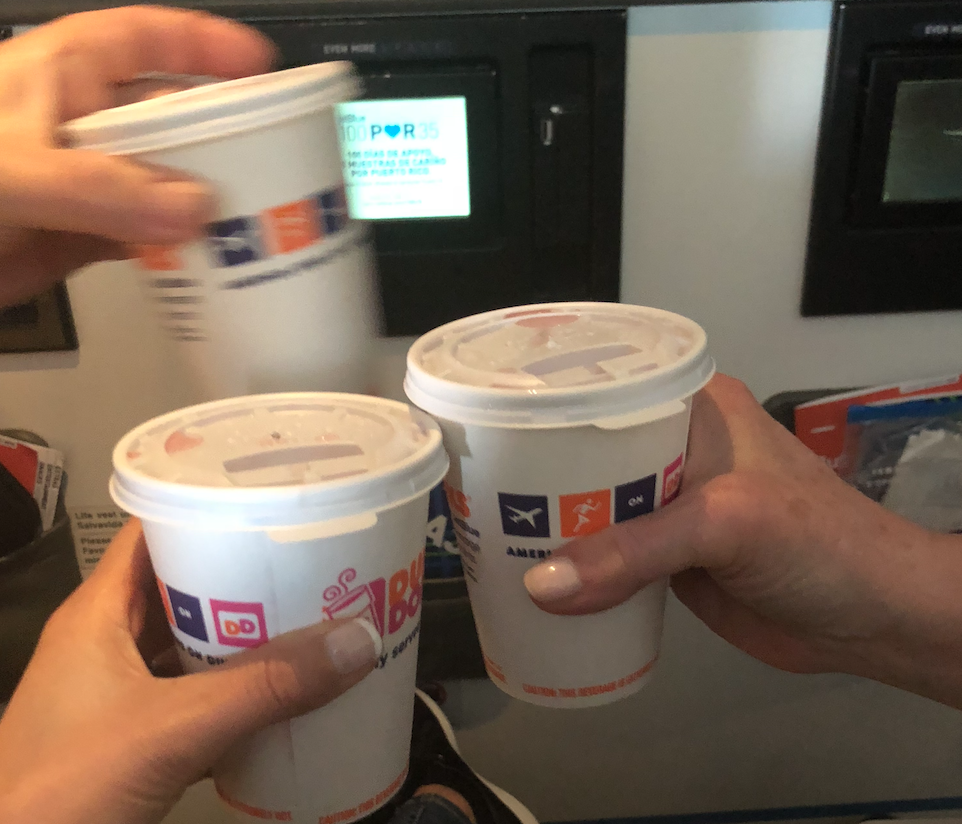 a group of hands holding cups