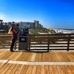 a couple of people on a boardwalk
