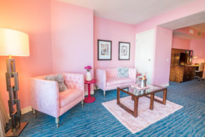 a living room with pink furniture