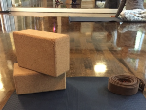 a yoga mat and blocks on a hardwood floor
