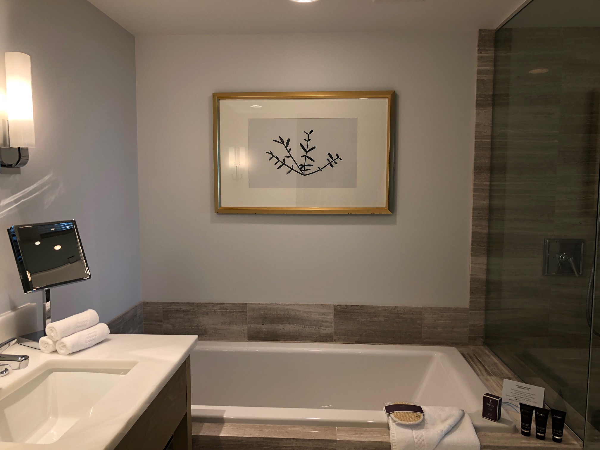 a bathroom with a framed picture on the wall