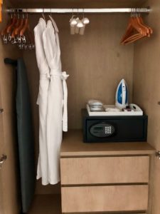 a closet with a white robe and irons