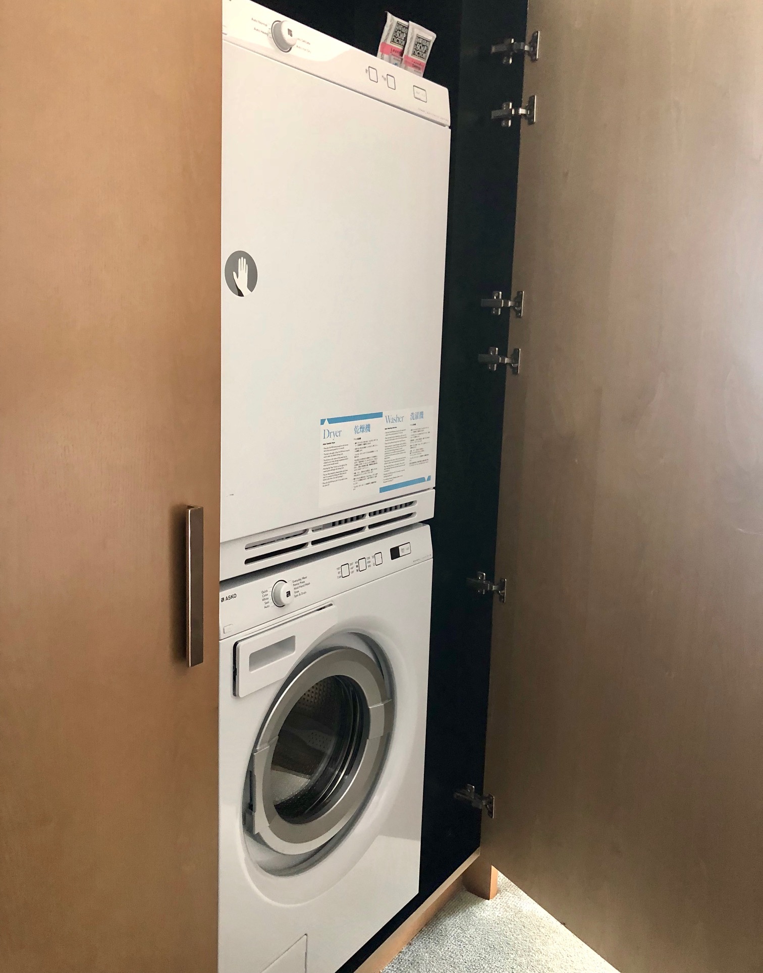 a white washer and dryer in a closet