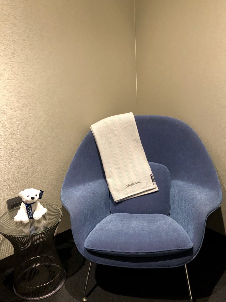 a blue chair with a white towel on it