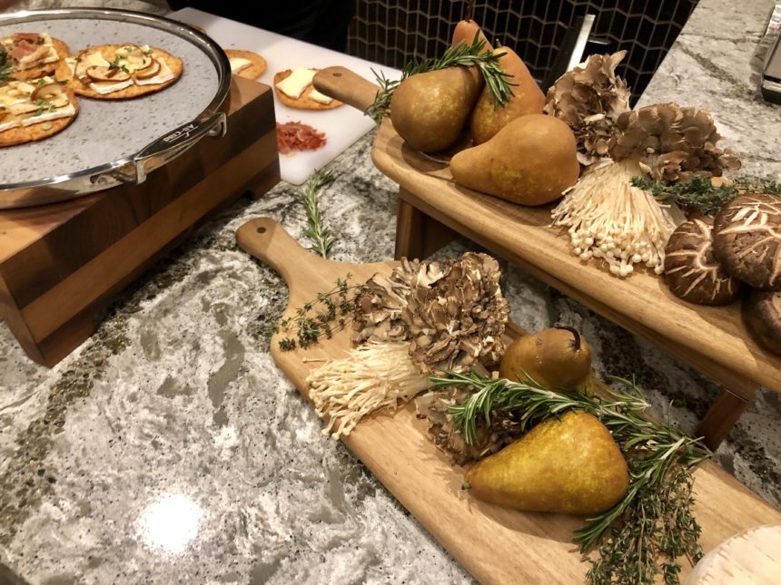 a group of wooden cutting boards with mushrooms and herbs on them