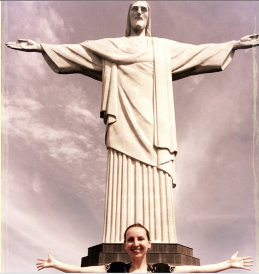 a woman standing in front of a statue