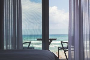 a room with a view of the ocean from the window