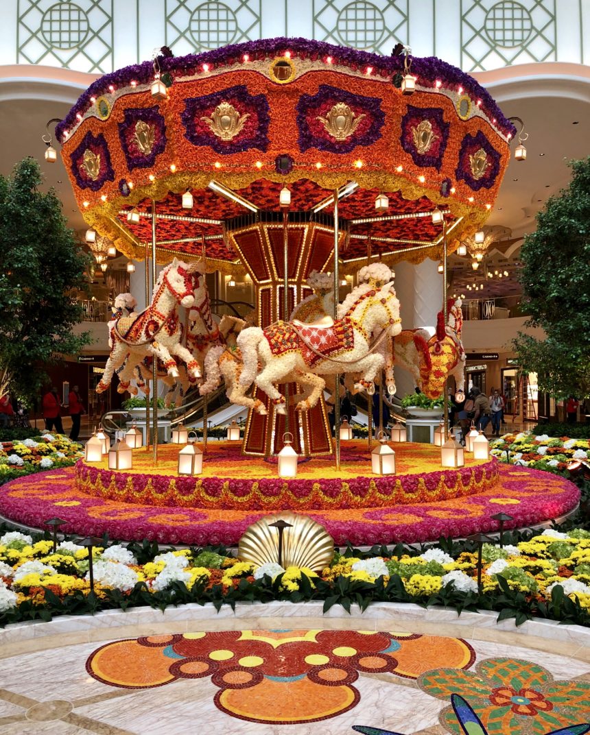a carousel with horses and flowers