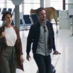 a man and woman walking in an airport