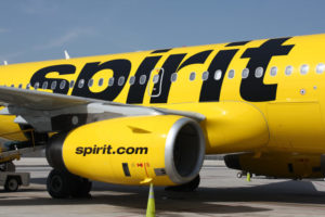 a yellow airplane with black writing on it
